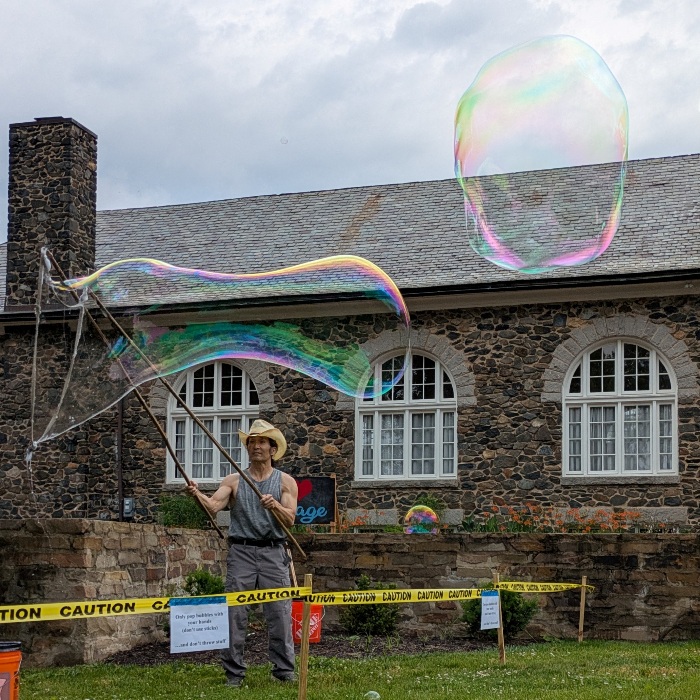 Me making bubbles with signs hung on the yellow tape