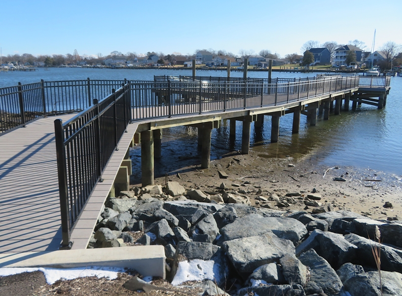 Black iron-railed kayak and fishing pier
