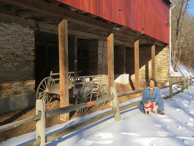Daphne and me near red barn with old wagon