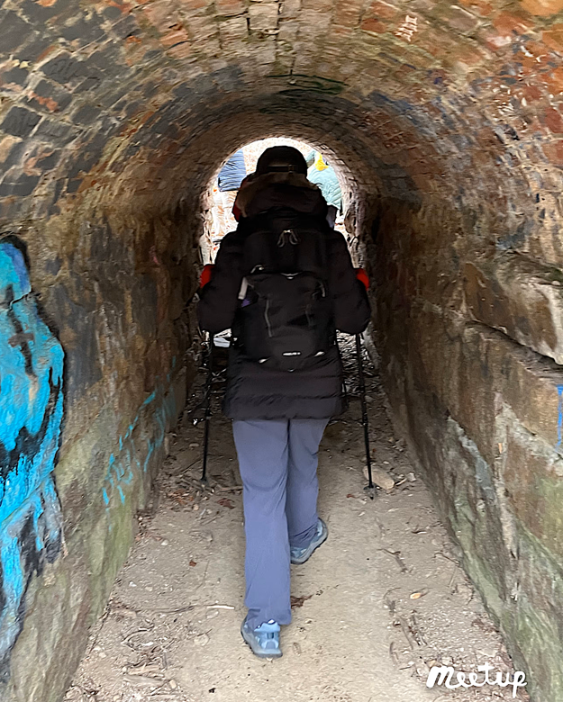 Person walking through the tunnel to the mill race